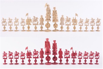 A Cantonese ivory Mandarin pattern chess set on puzzle ball stands (FS16/560).