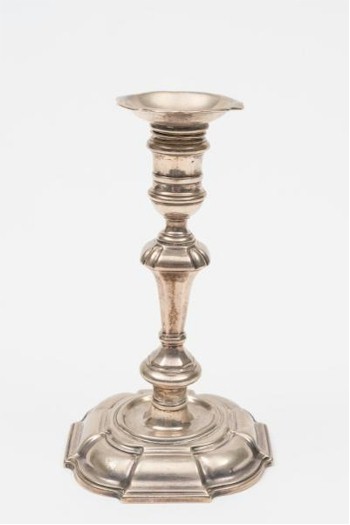 A George II cast silver candlestick by the London silversmith Matthew Cooper I made in 1728 (FS23/143) features in the
        Summer 2014 Fine Sale.