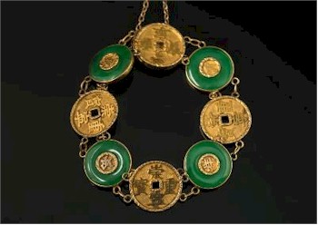 A Chinese Gold and Green Jade Disc Panel Mounted Bracelet (FS26/231) is inviting bids of between £300 and £400.