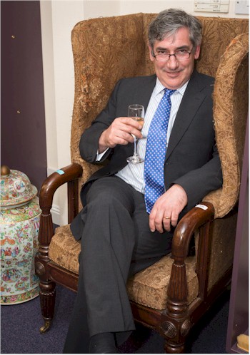 Clocks expert Leigh Extence passes some time in a comfortable Regency wing chair.