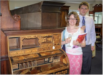 Christelle Bonnel and Mark Johnstone with a Japanese inlaid bureau at the Bearnes Hampton
        & Littlewood preview evening for the Summer Fine Art Sale which will take place
        on 14th and 15th July 2015.