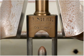A detail from a 19th Century triple cylinder, single-acting diver's pump with water pump pulley by Augustus Siebe.