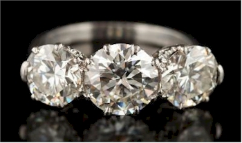 A graduated diamon three stone ring (FS36/336) realised £13,000.