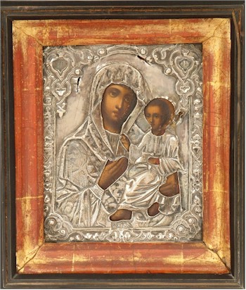 A late 19th century Russian Icon of The Madonna and Child the image contained within a silver oklad.