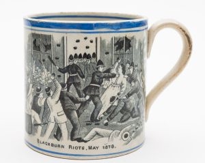 A Staffordshire pottery mug showing the cotton riots in Blackburn (FS35/697).