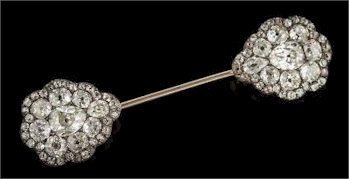 This diamond mounted jabot pin (FS37/485) displays pear shaped, cushion shaped and
        round old-cut diamonds of good colour and clarity.