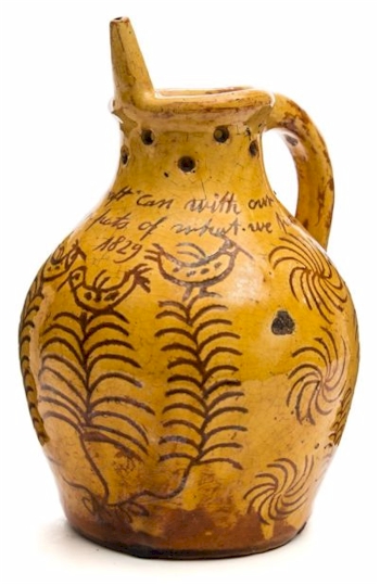 A Donyatt pottery puzzle jug with skinny hen decoration.