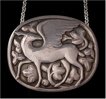 A Georg Jensen oval pendant/brooch depicting a winged deer amongst foliage, the
        reverse with pre-1930s maker's marked 'GI'.