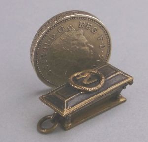 a diminuative gilt metal model of napoleon's coffin.