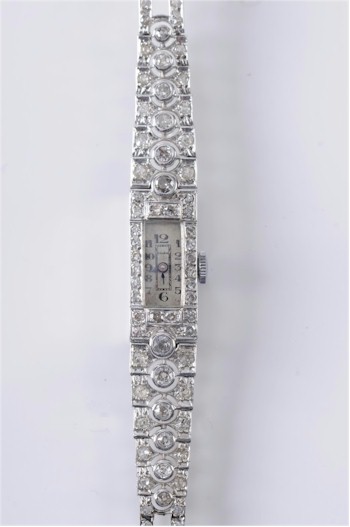 A lady's diamond mounted cocktail wristwatch. Estimate £800-£1,200.