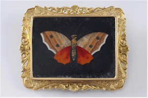 A pietra dura rectangular panel brooch with central butterfly motif. Estimate £300-£400.