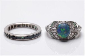 An early 20th century black opal, emerald and diamond cluster ring (left), estimate £800-£1,200 with a platinum and diamond single-stone ring (right), estimate £4,000-£6,000.