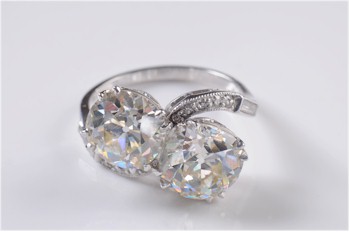 A platinum and diamond two stone cross-over ring being offered in the Jewellery section of the April 2013 Fine Sale that carries
         a pre-sale estimate of between £15,000 and £18,000 (FS18/294).