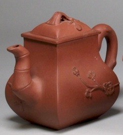 An Yixing teapot of more restrained form with bamboo spout and prunus decoration (Part of FS18/477).