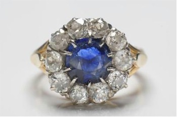 A sapphire and diamond round cluster ring, with single cushion-shaped sapphire (FS19/161).