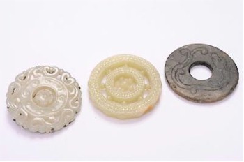 The oriental artefacts in the auction, whether ceramics or works of art, attracted great interest and intense bidding.
        These three Chinese jade and hardstone pendant discs (FS20/823) sold for £23,000.