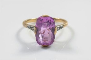 A cushion shaped pink sapphire single stone ring (FS21/211) is being offered with an estimate of £800-£1,200 in the jewellery
        auction of the sale.