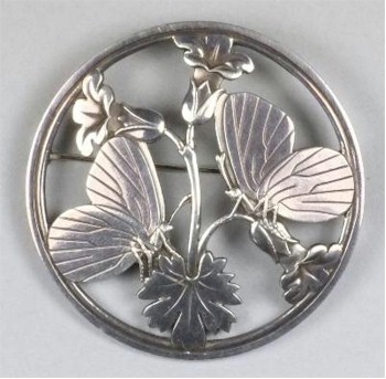 A late 1950s George Jensen silver circular brooch (stamped with design number 283) is being offered in the January 2014 Fine Sale
        with a pre-sale estimate of £150-£250 (FS21/183).