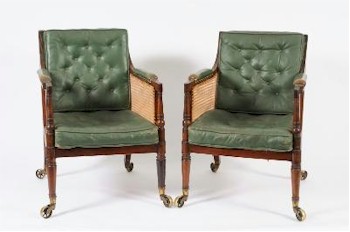 A fine pair of Regency mahogany bergere library armchairs (FS21/907) from a Devon country mansion personify English elegance.