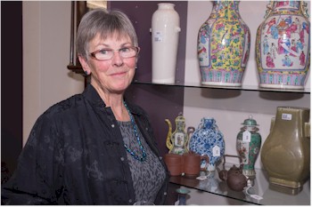 Angela White from Exeter examines some far eastern ceramics at the private view for the
        forthcoming Bearnes Hampton & Littlewood Fine Art Sale in January 2014.