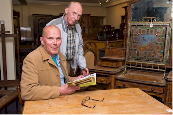 Tim Jennings and Mike Moore look at furniture at the preview evening for the West Country Spring 2014 Fine Art Auction.