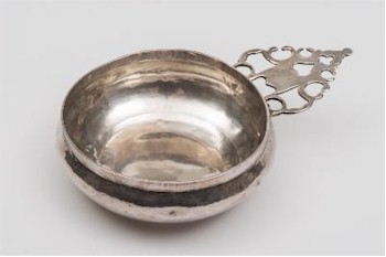 The Queen Anne silver bleeding bowl (FS26/142) made in Exeter in 1707 by the silversmith John Elston realised £2,800.
