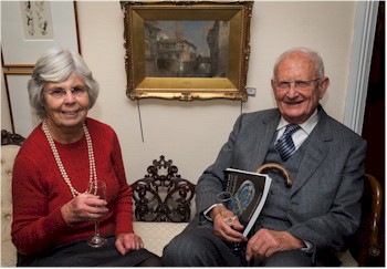 Sylvia and William Burkinshaw take a seat to admire a painting of Grenada by David Roberts.