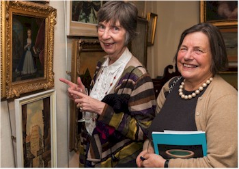 Judie Yung and Beryl Whidden look at an 18th century Dutch school portrait.