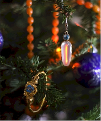 A ring and pendant displayed on a Christmas tree.