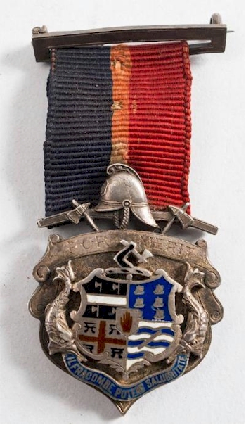 A silver and enamel medal presented to Gumm in recognition of his role in tackling
        the Great Fire of Ilfracombe in 1896 (SC31/257).