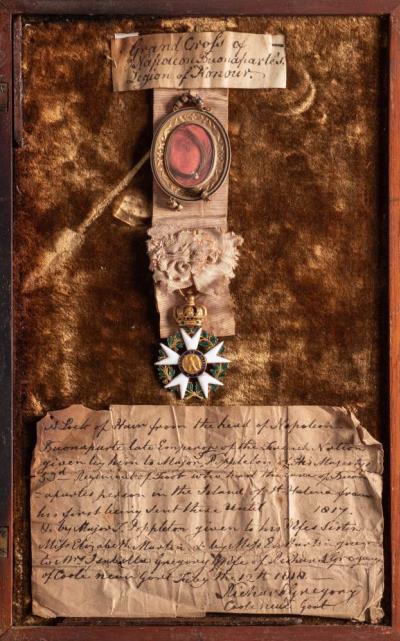 Napoleon Bonaparte (1769-1821): A lock of Napoleon's hair in a Gilt Oval Locket
        on a Crimson Ribbon, together with a Gilt and Enamel Legion d'Honneur and Manuscript
        Provenance, dated July 12th 1818 (MA20/343) offered in our Maritime Auction starting
        on 19th October 2021 at our salerooms in Exeter, Devon.