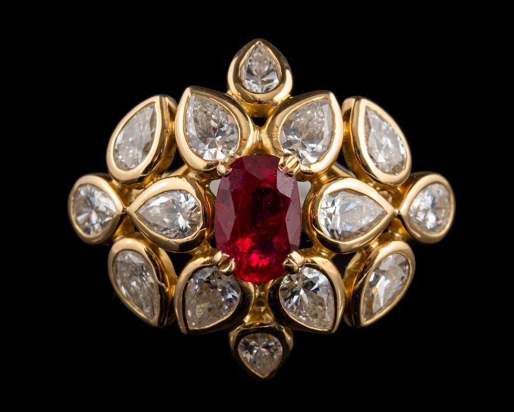 A Ruby And Diamond Ring By Cartier, The Central Oval Cut Ruby
