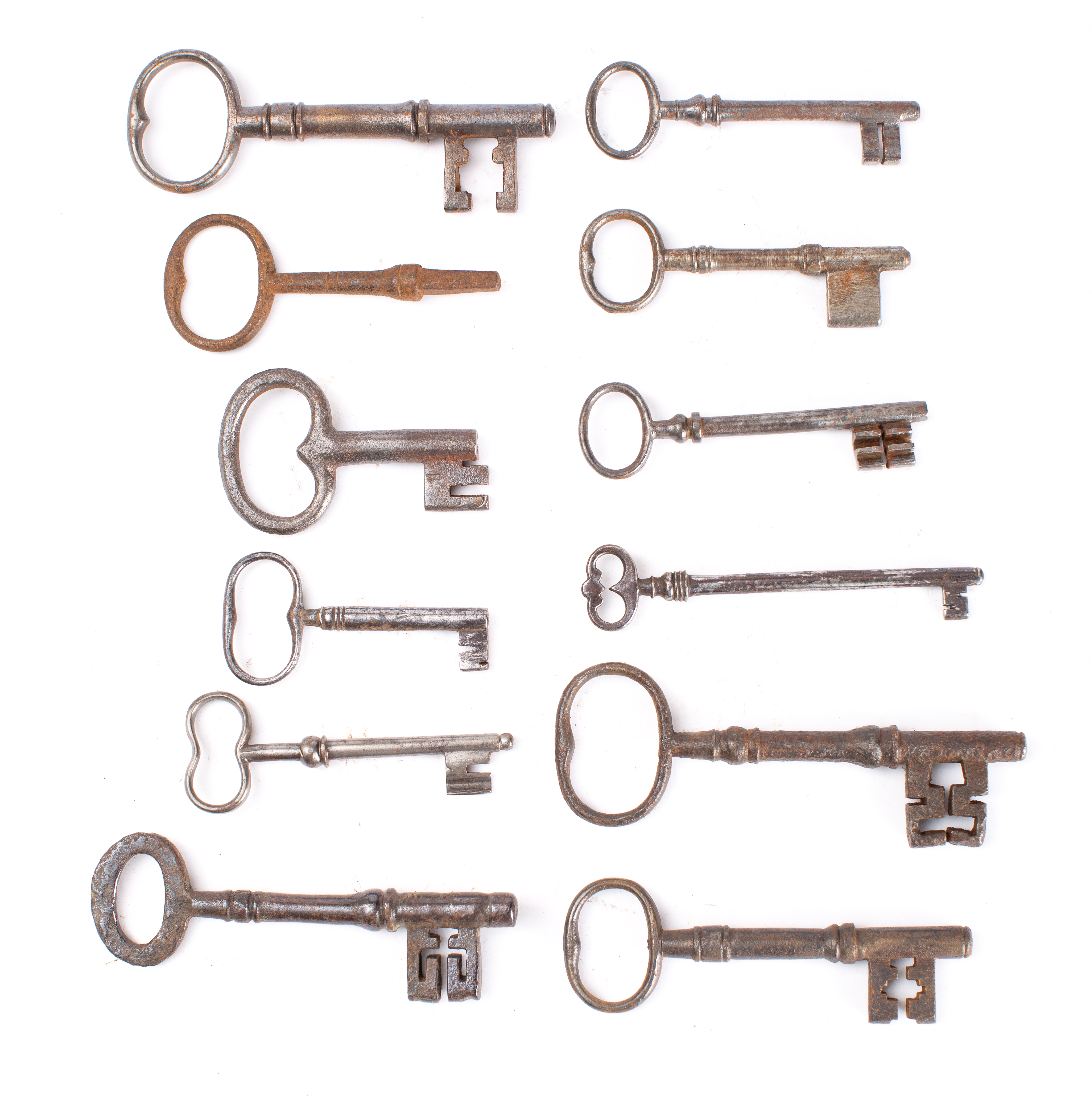 A group of twelve various steel keys, both English and French: including two blank keys 